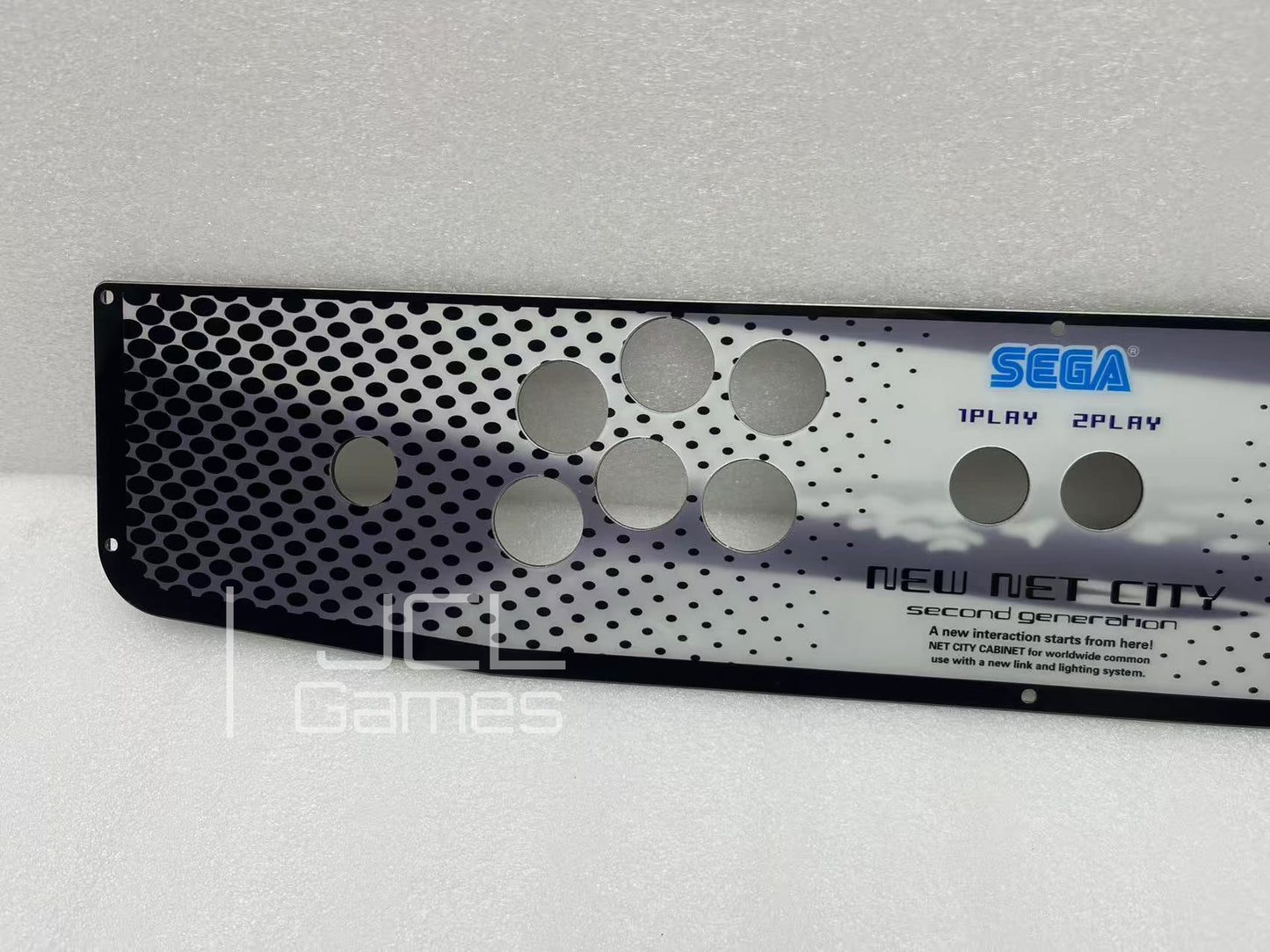 Close up of stainless steel material on Sega arcade panel
